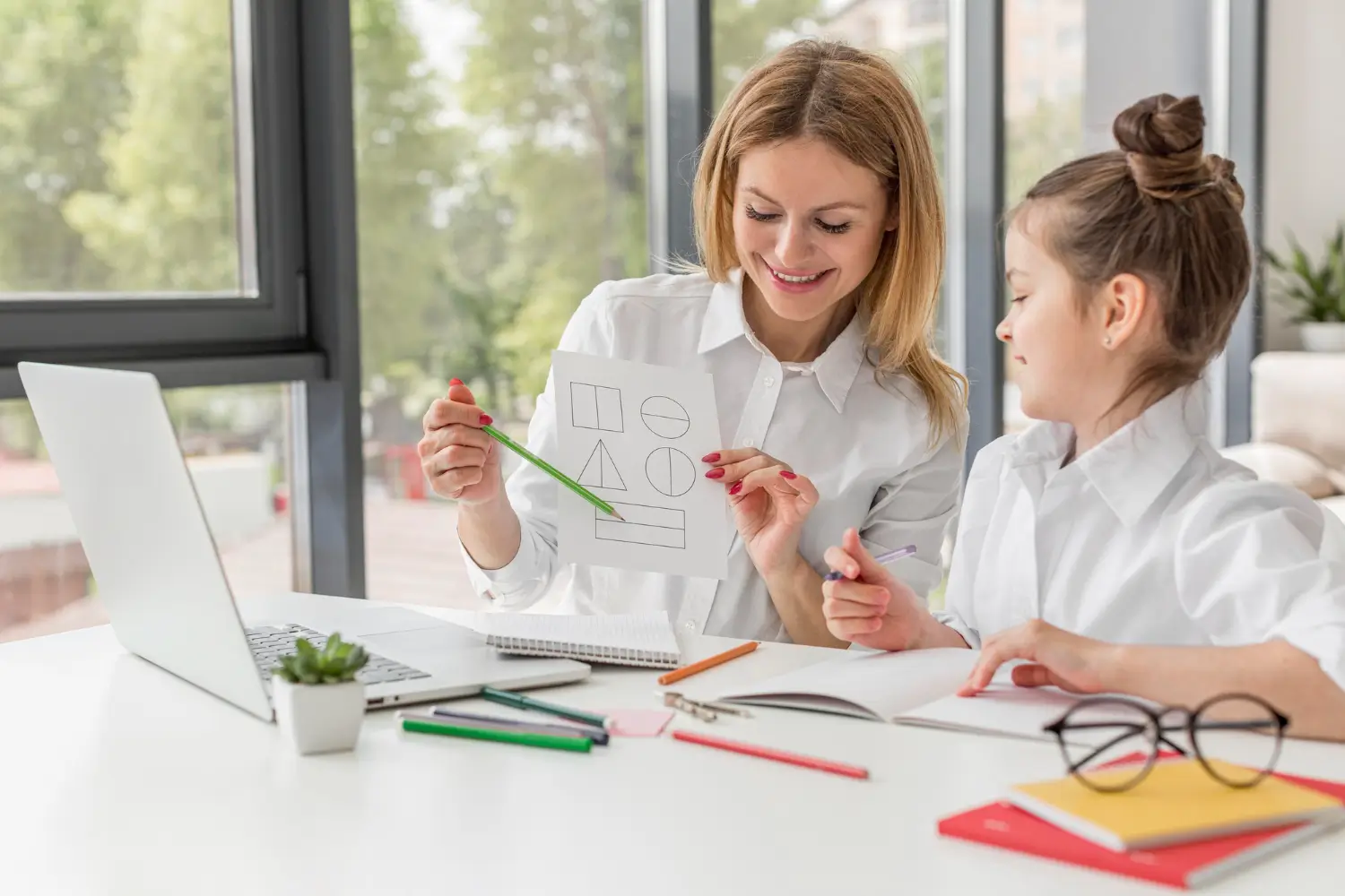 Educational consultant guiding a student through a learning activity during a homeschool planning session in Pompano Beach, Florida.