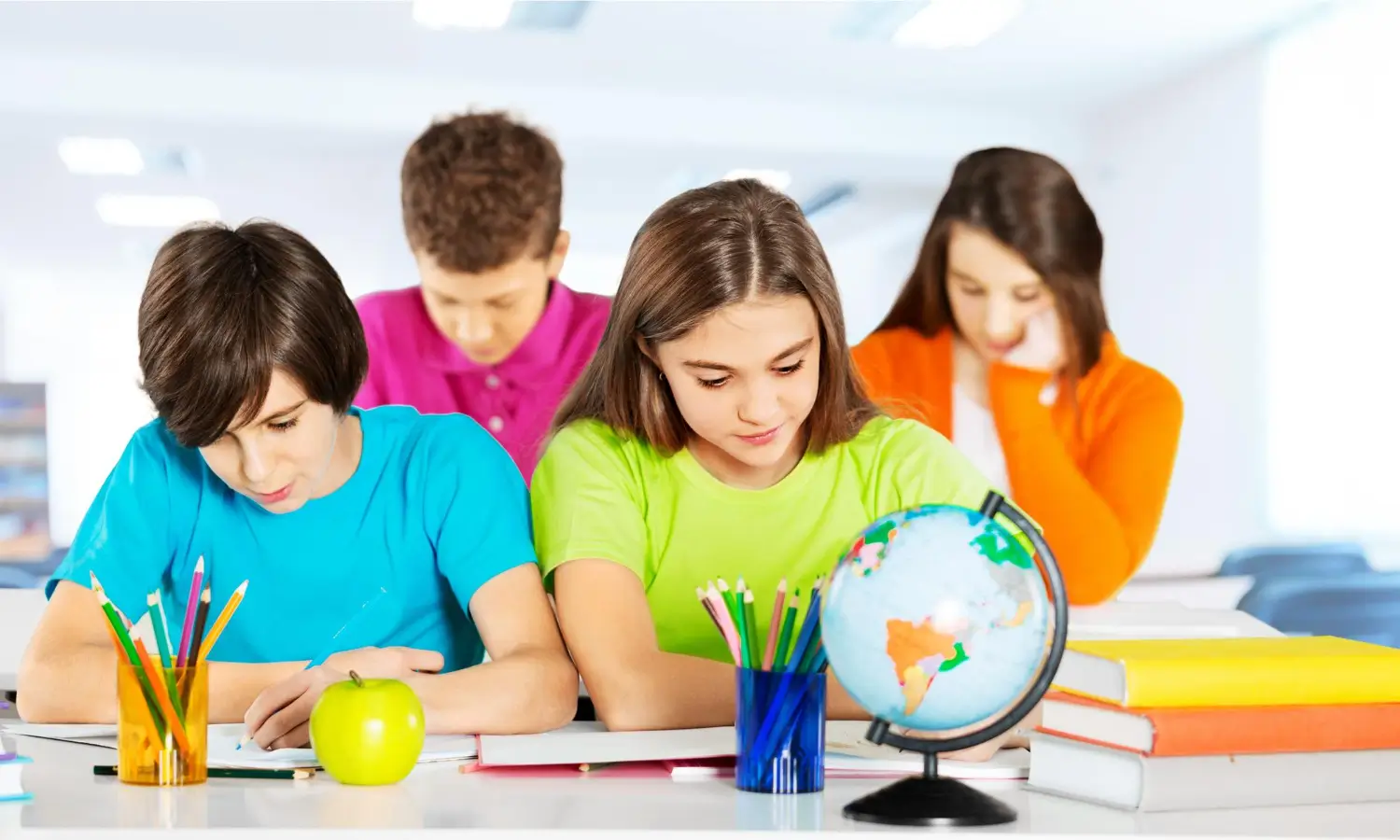 K-12 students completing schoolwork with books and a globe during a supported homeschool learning session.